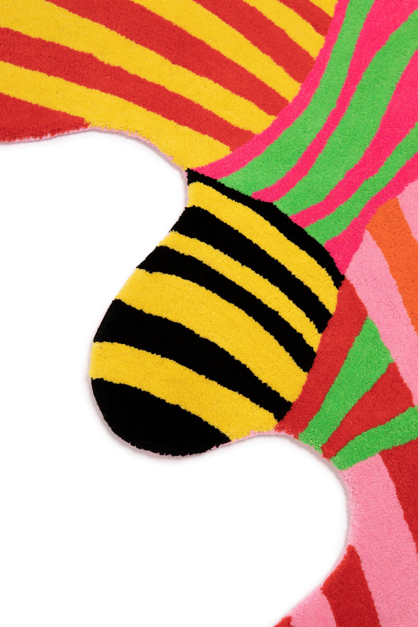 Close up of squiggle stripe rug showing the irregular squiggle shape and details of the multicolor tufted stripes.