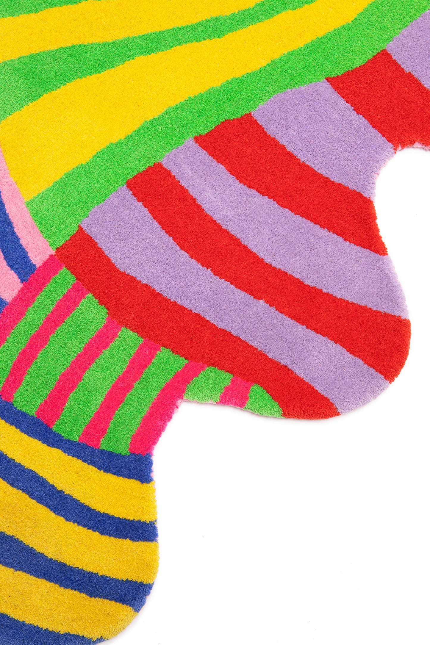 Close up of squiggle stripe rug showing the irregular squiggle shape and details of the multicolor tufted stripes.
