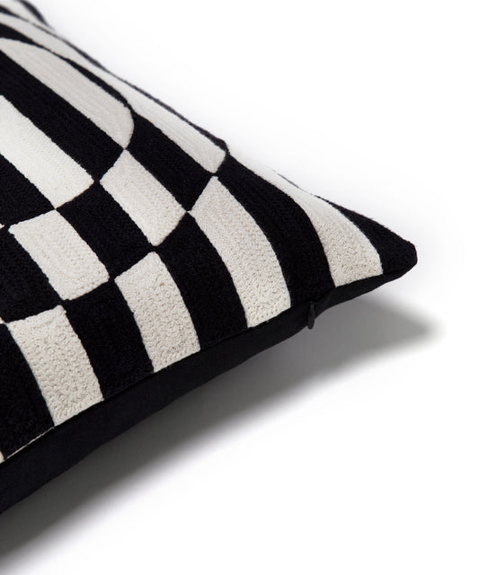Close up of the corner of the Dazzle Pillow Cover. Showing the black and white stripes and zipper opening.