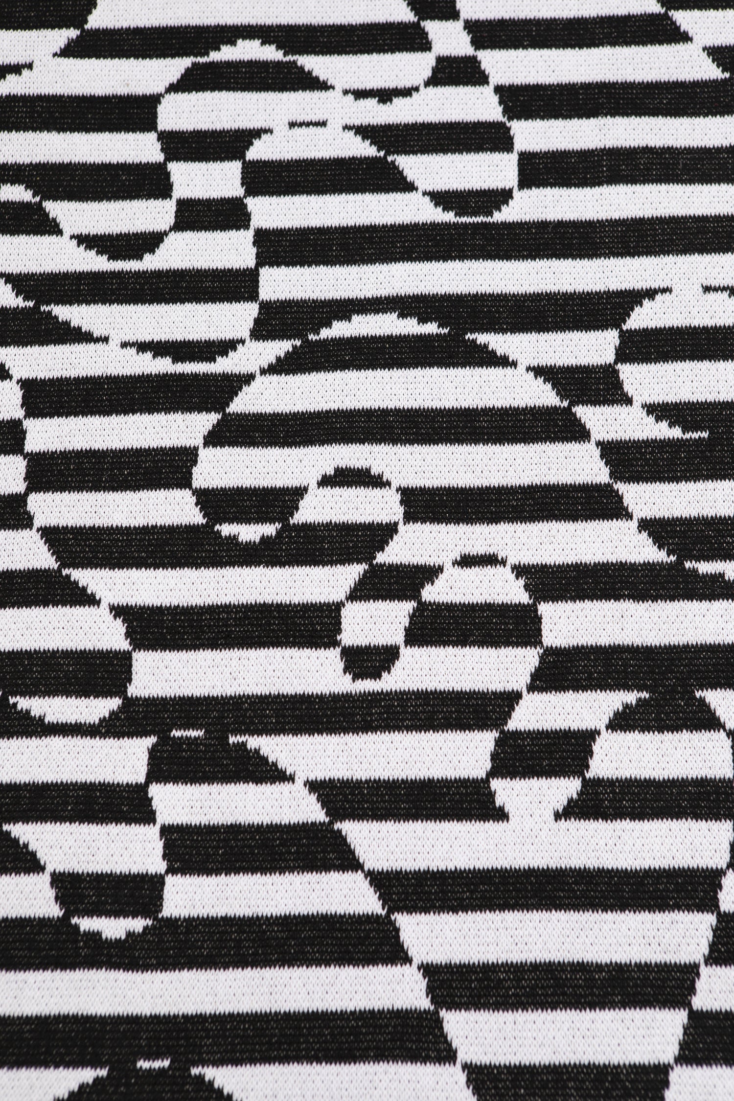 Close up of Dazzle Blanket showing the black and white striped swirl pattern.