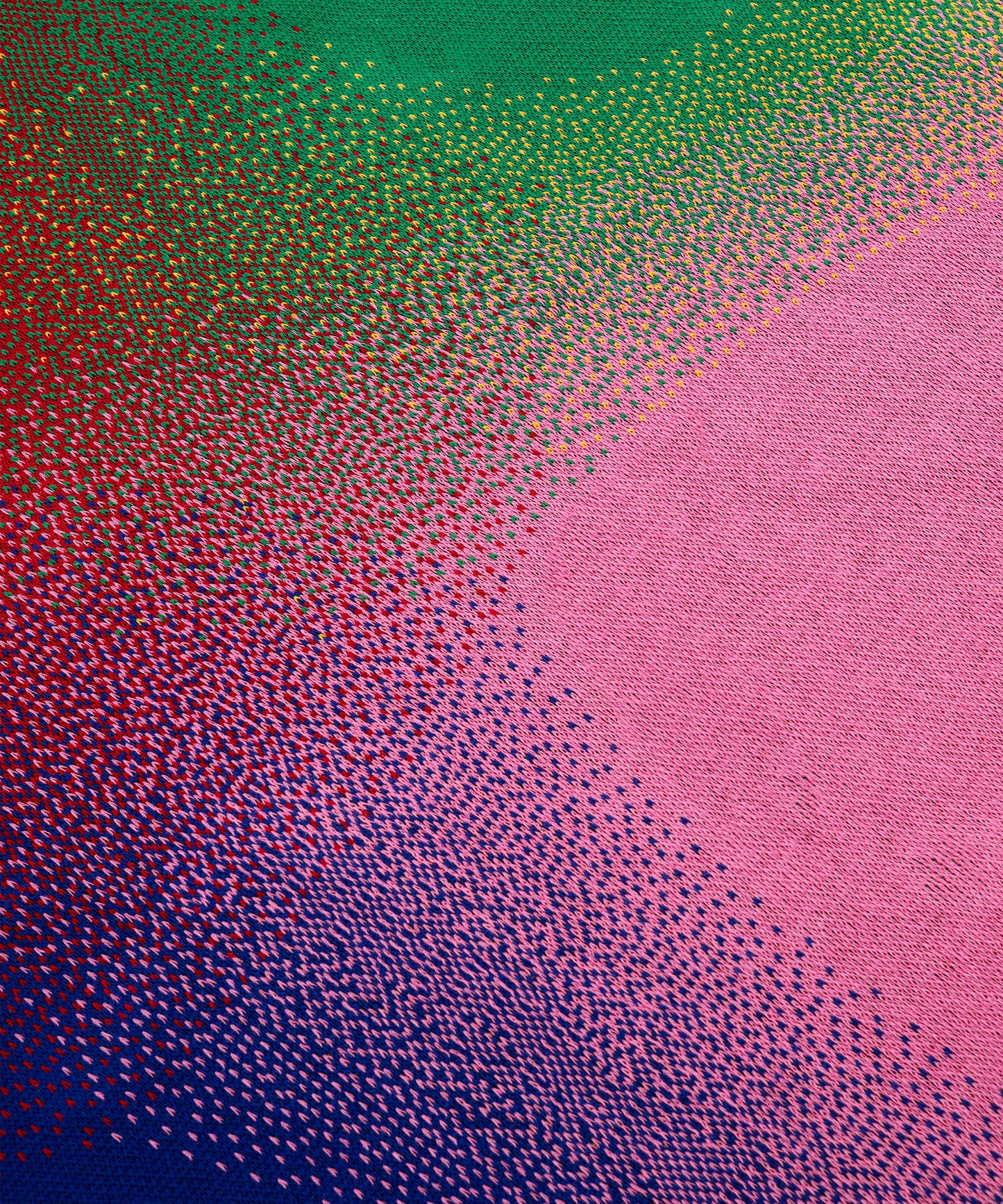 Close up of Aura Blanket showing knit details with all 5 colors- Red, yellow, blue, pink, green.