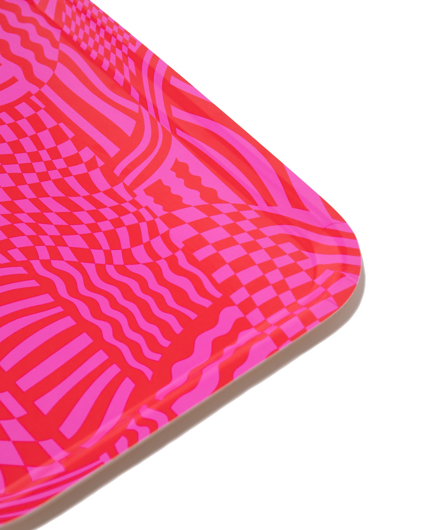 Corner detail of the Wiggles and Waves Tray showing the pink and red abstract design.