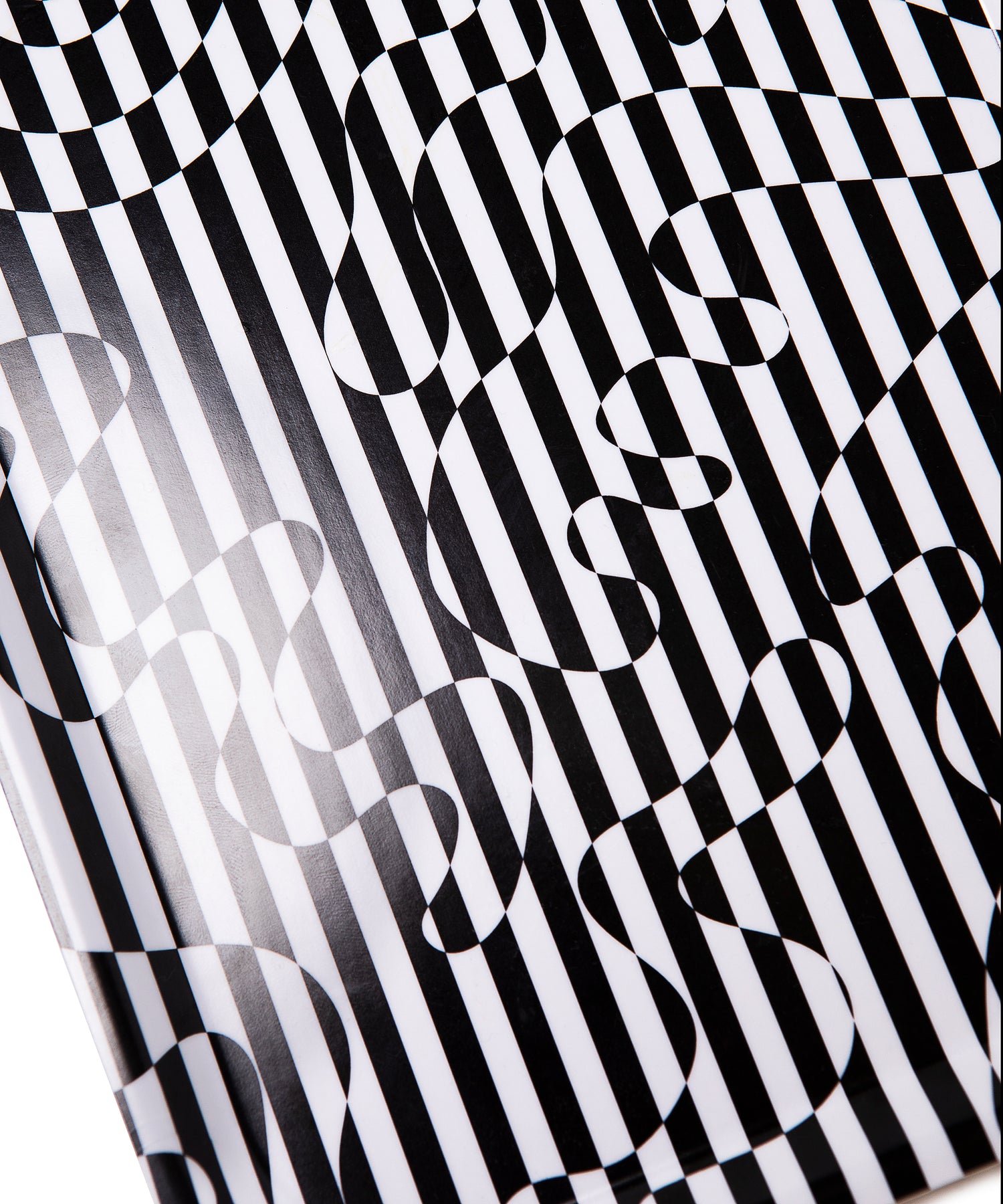 Close up of Dazzle Tray showing the black and white striped swirl design with a glossy sheen.