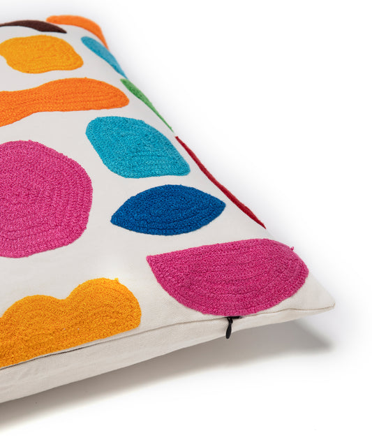 Detail of the corner of the Odds and Ends pillow cover showing the colorful organic shapes and the zipper opening.